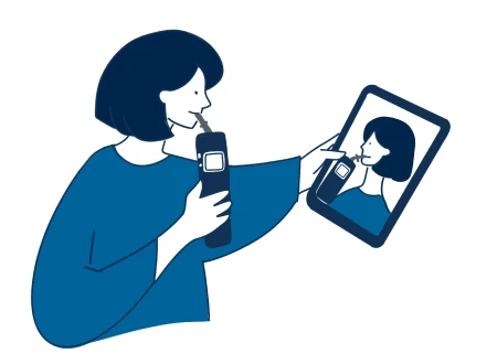 スマートフォンの画面を見ながらアルコールチェッカーに息を吹き込むイラスト